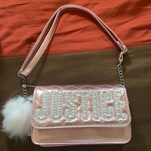 This kids purse is from Justice. It’s rose gold, with a white Pom Pom.